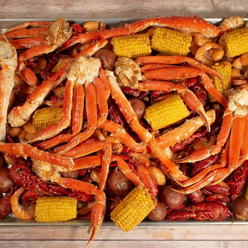 Platter of snow crab legs, crawfish, shrimp, corn and potatoes at Wild Crab House, a Seafood Restaurant in Staten Island