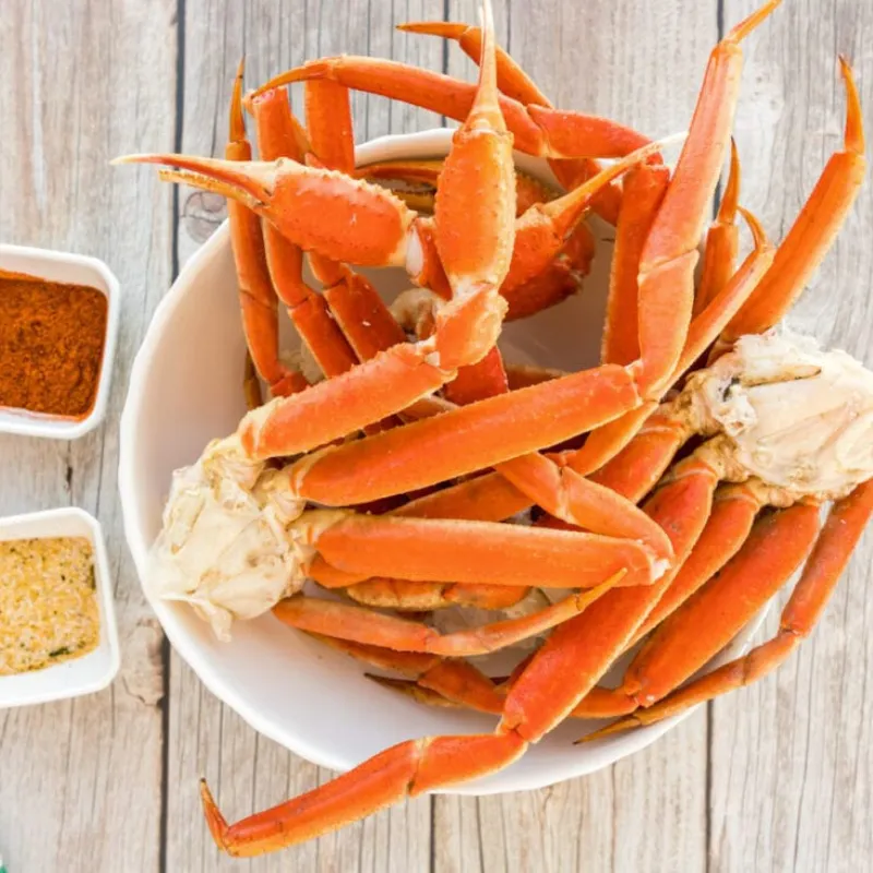 Steamed snow crab legs with two portions of dipping seasonings at Wild Crab House, a Seafood Restaurant in Staten Island